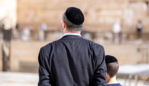 An undefined orthodox Jewish man and his son come to pray at the Western Wall. Jerusalem. Israel