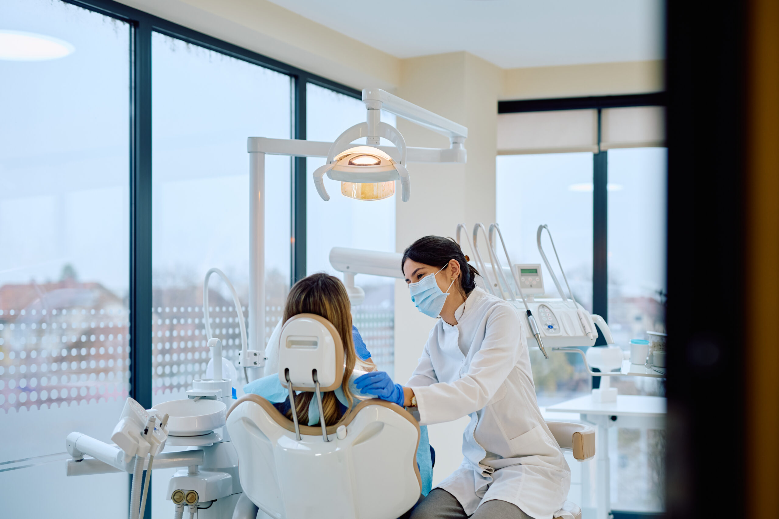 Female dentist examining patient during dental check-up